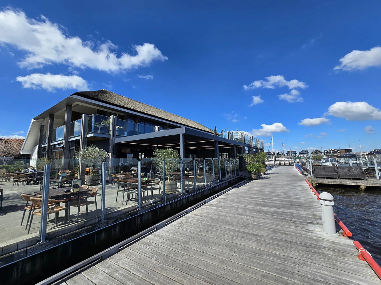Compleet horecaterras aan een jachthaven met overkapping, glas en zitplaatsen